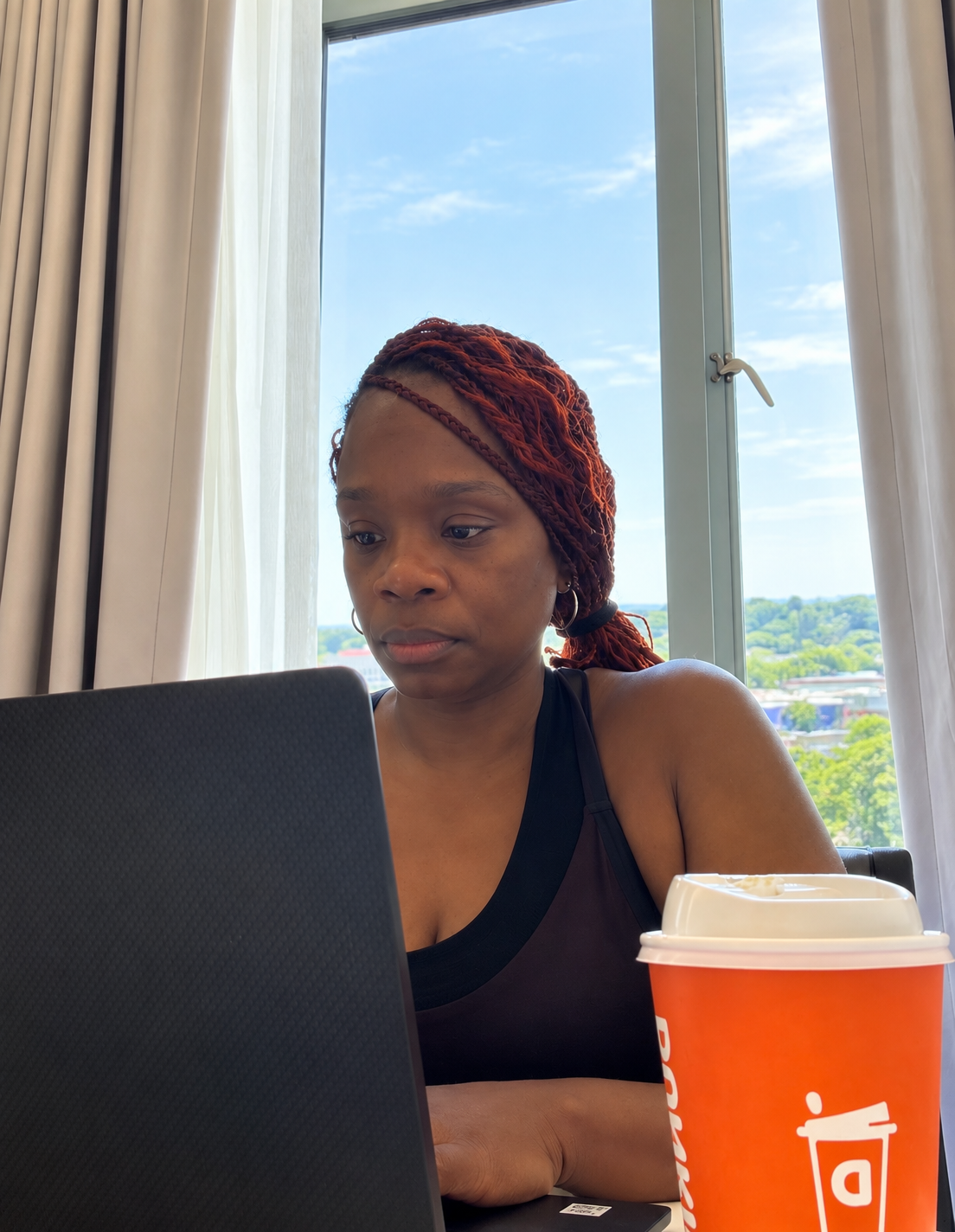 Anna working on her laptop with a coffee nearby
