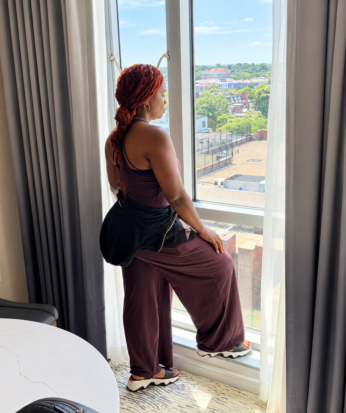 Anna standing confidently by a bright window